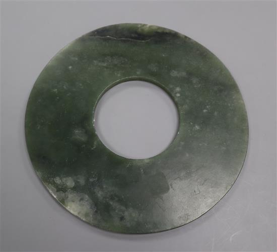 A Chinese spinach green jade bi disc 15.4cm